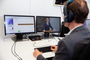 Man kijkt naar twee schermen