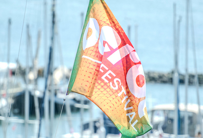 Wapperende vlag van Oerol in de haven van Terschelling